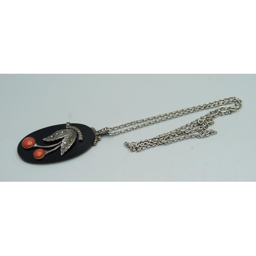 1042 - An 830 silver mounted coral, onyx and marcasite pendant