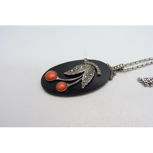 1042 - An 830 silver mounted coral, onyx and marcasite pendant