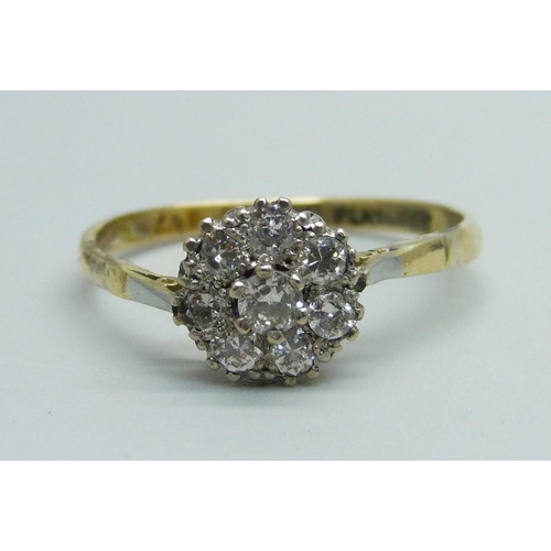 1043 - An 18ct gold and platinum set diamond cluster ring, 2.5g, T