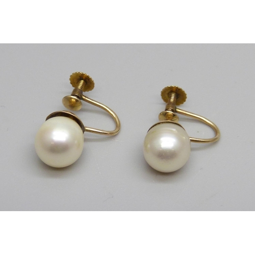 1060 - A pair of 9ct gold mounted screw back pearl earrings, approximately 8mm, (one requires repair)