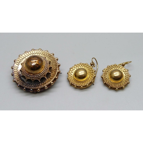 1063 - A Victorian yellow metal brooch and a pair of similar earrings, 16.3g, (earrings test as high carat ... 