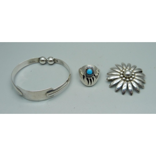 1064 - A silver bangle, a silver ring and a Hermann Siersbol Denmark brooch