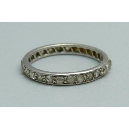 1076 - A white metal and diamond eternity ring, 2.1g, J