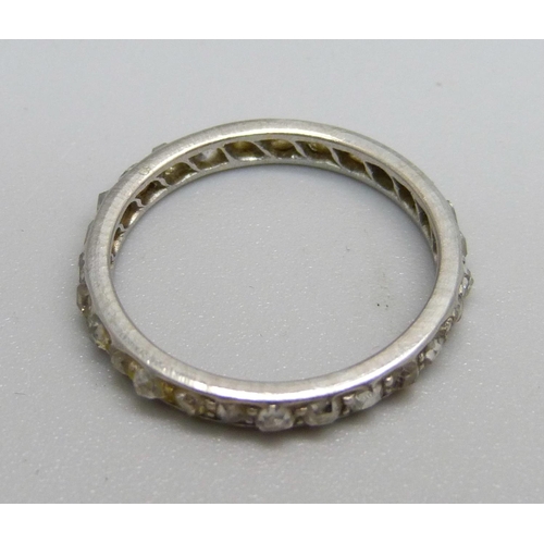 1076 - A white metal and diamond eternity ring, 2.1g, J