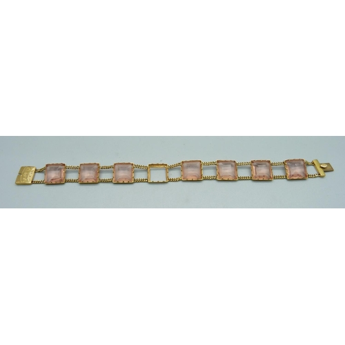 1079 - A yellow metal set pink glass panel bracelet, 17.4g, lacking one panel