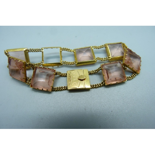 1079 - A yellow metal set pink glass panel bracelet, 17.4g, lacking one panel