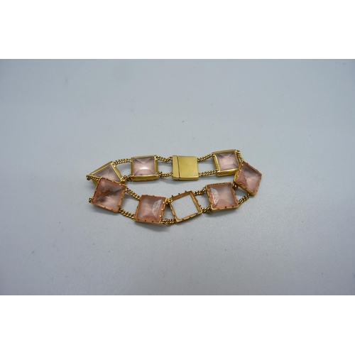 1079 - A yellow metal set pink glass panel bracelet, 17.4g, lacking one panel