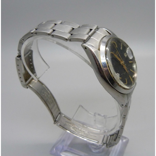 1086 - A late 1950's/early 1960's Rolex Oysterdate wristwatch, black dial with gold hour markers and hands,... 