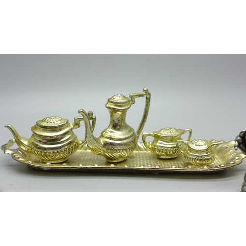 634 - A metal miniature tea service and trinket pots