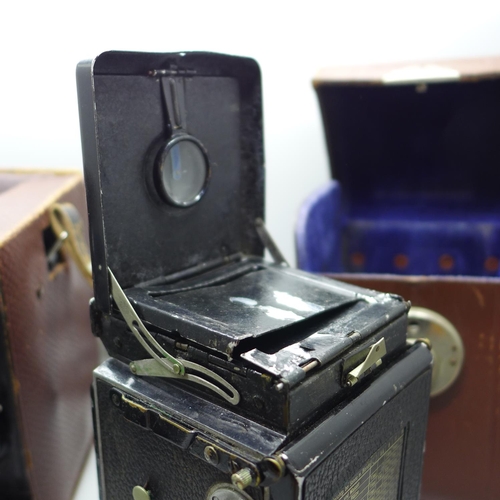 649 - Two Rolleiflex TLR cameras, one with Carl Zeiss lenses, cased and a Voigtlander TLR camera, cased