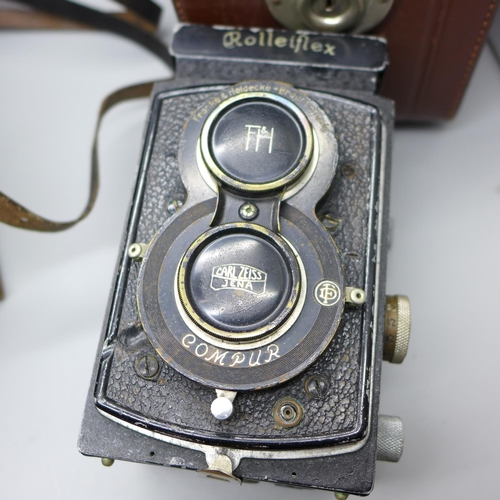 649 - Two Rolleiflex TLR cameras, one with Carl Zeiss lenses, cased and a Voigtlander TLR camera, cased