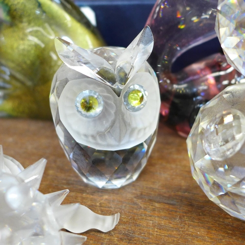 690 - A collection of Swarovski crystal animals, four glass fish and a Stuart Crystal paperweight