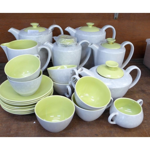 694 - Poole pottery tea wares, five tea and coffee pots, cups and saucers, etc., one lid a/f