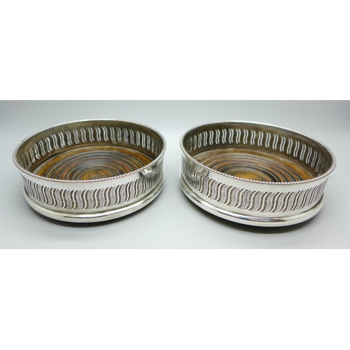699 - Two silver plated wine coasters