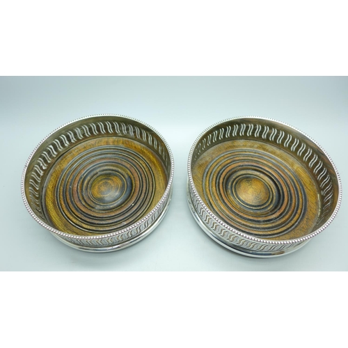 699 - Two silver plated wine coasters