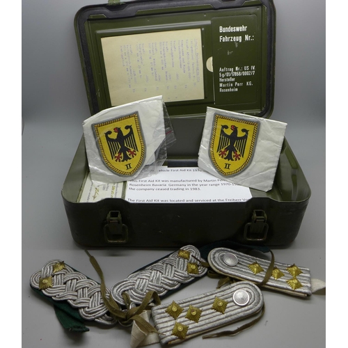 716 - A Bundeswehr vehicle first aid tin, 1970-1980, two patches and two sets of shoulder boards