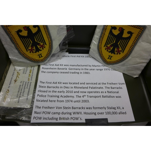 716 - A Bundeswehr vehicle first aid tin, 1970-1980, two patches and two sets of shoulder boards