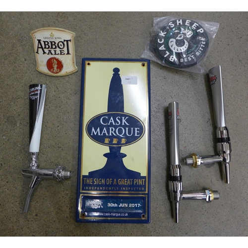 729 - A Cask Marque enamenl sign with beer pump, handles and beer pump badges