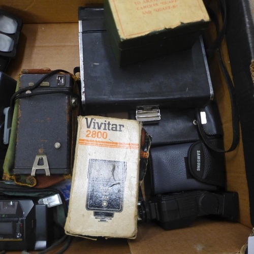 731 - A collection of cameras and camera slides, slides include a 1970s motor show and European travel