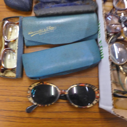 766 - A collection of approximately 25 mid-20th century lady's spectacles and cases