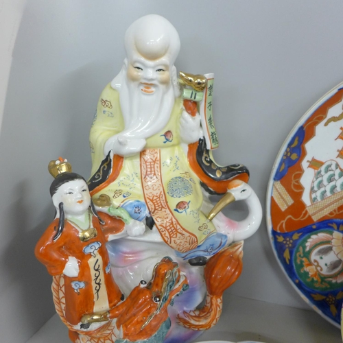 827 - Two Chinese chargers, an Imari plate, ginger jar and two large oriental figures, one a/f