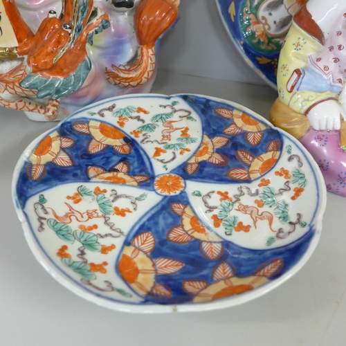 827 - Two Chinese chargers, an Imari plate, ginger jar and two large oriental figures, one a/f