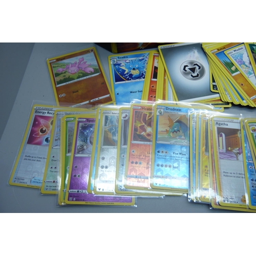 838 - 30 Holo/reverse holo and 300 common/uncommon/rare Pokemon cards in tin