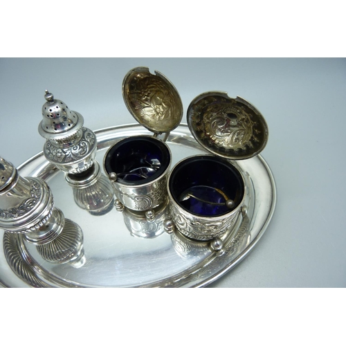 875 - Two Victorian silver rococo style mustards and two Victorian silver peppers with a later oval silver... 