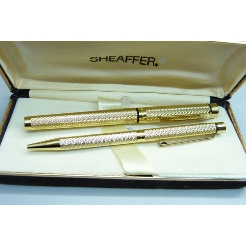 881 - A Sheaffer ink pen with 14k gold nib and ballpoint pen set, boxed and two Cross ballpoint pens, both... 