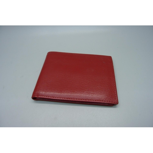 902 - A red leather Rolex wallet