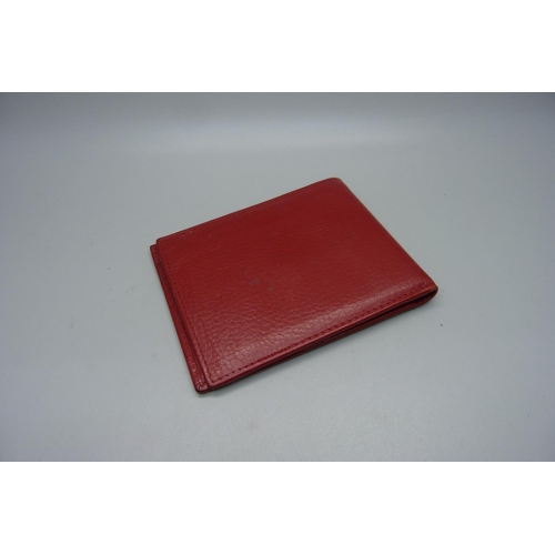 902 - A red leather Rolex wallet