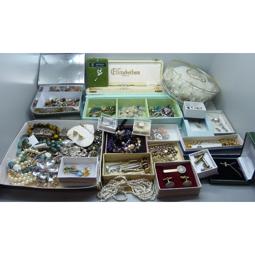 950 - A large collection of costume jewellery including bracelets, earrings, a tiara, cufflinks, etc.