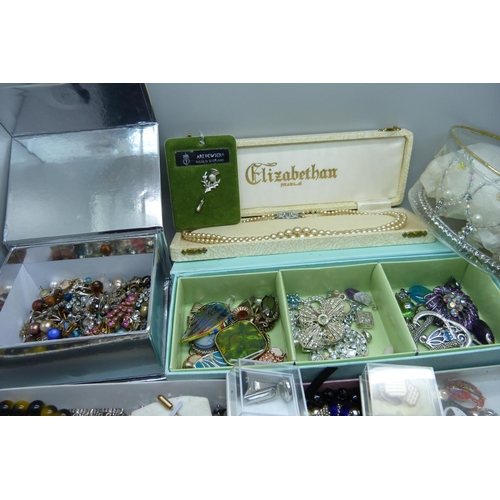 950 - A large collection of costume jewellery including bracelets, earrings, a tiara, cufflinks, etc.