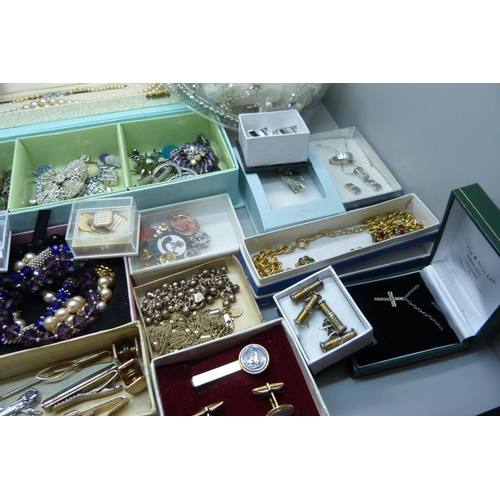 950 - A large collection of costume jewellery including bracelets, earrings, a tiara, cufflinks, etc.