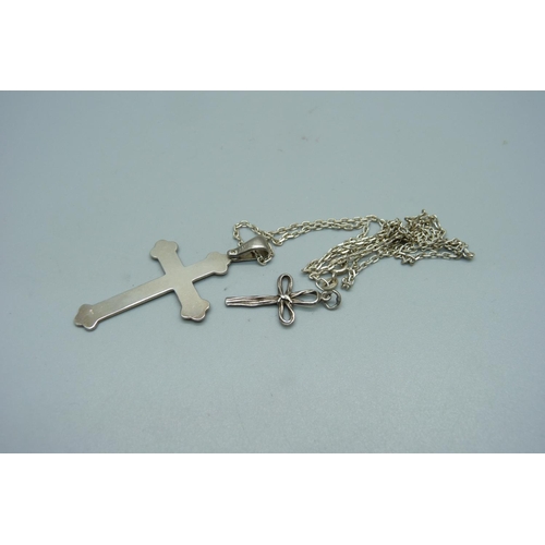 983 - A silver cross pendant and chain and one other cross pendant