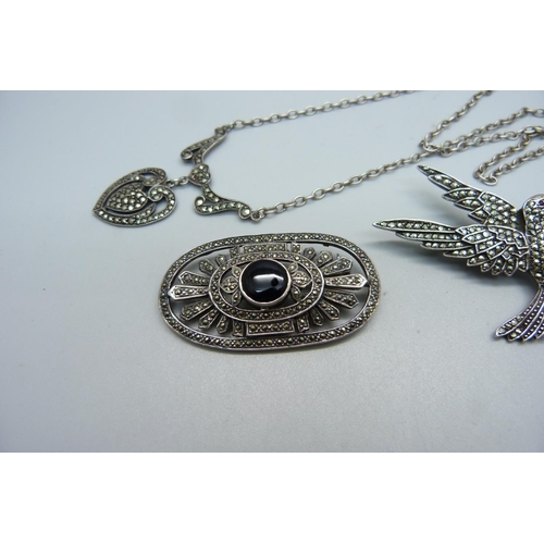 996 - Two silver and marcasite brooches and a similar necklace