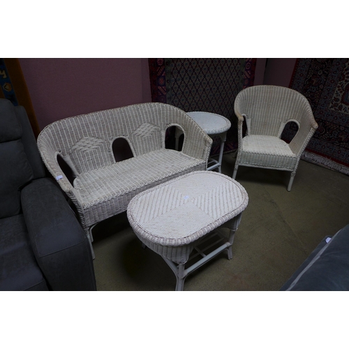 1524 - A white painted wicker conservatory set including two seater sofa, armchair, coffee table and side t... 