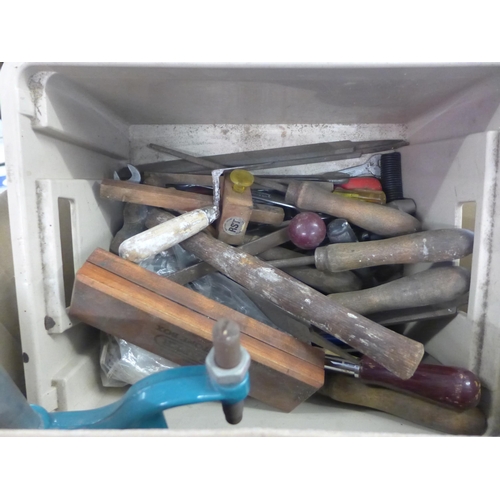 2421 - A box of woodworking tools including a drill stand, files and chisels, a plastic tub containing nail... 