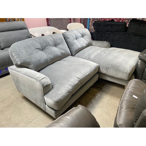 1541 - A grey velvet L shaped sofa on turned legs