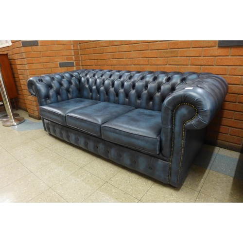 1 - A blue leather Chesterfield settee