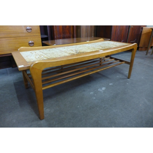 100 - A teak and tiled top coffee table