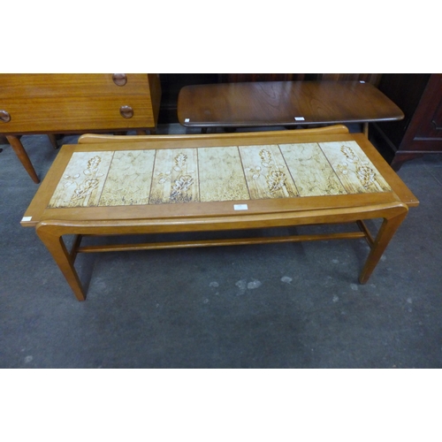 100 - A teak and tiled top coffee table