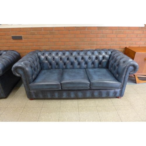 2 - A blue leather Chesterfield settee