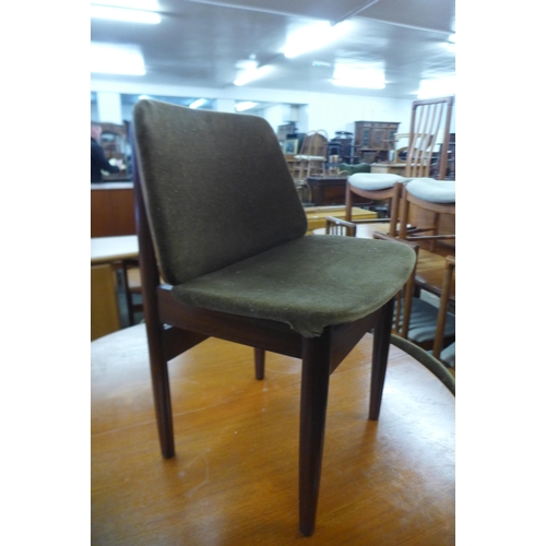 35 - A teak circular extending dining table and four Elliotts of Newbury teak dining chairs