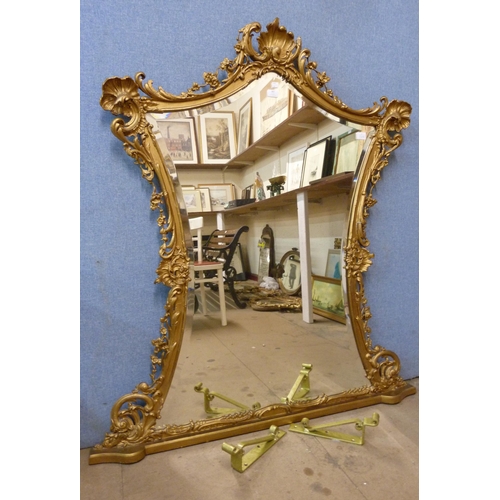 387 - A 19th Century French Rococo Revival carved giltwood and gesso overmantel mirror