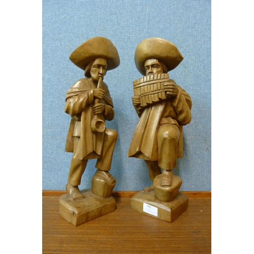 395 - A pair of South American carved wood figures of musicians