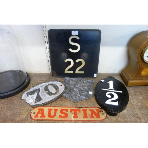 402 - Two cast iron plaques, two steel plaques and a tin Austin sign