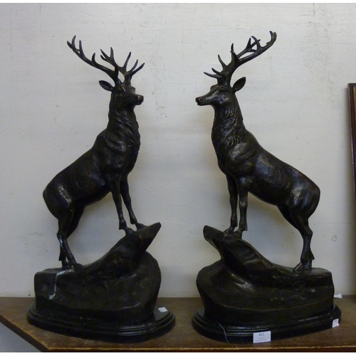 411 - A pair of bronze figures of stags, on black marble socle