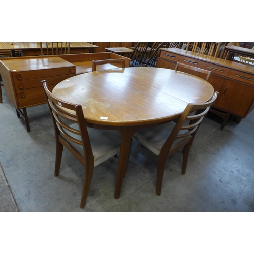 42 - A McIntosh teak extending dining table and four teak dining chairs