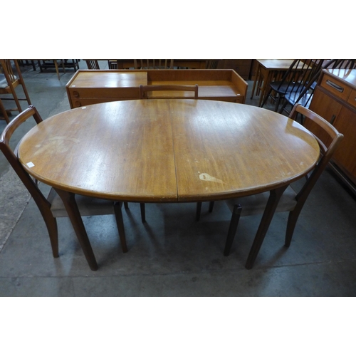 42 - A McIntosh teak extending dining table and four teak dining chairs